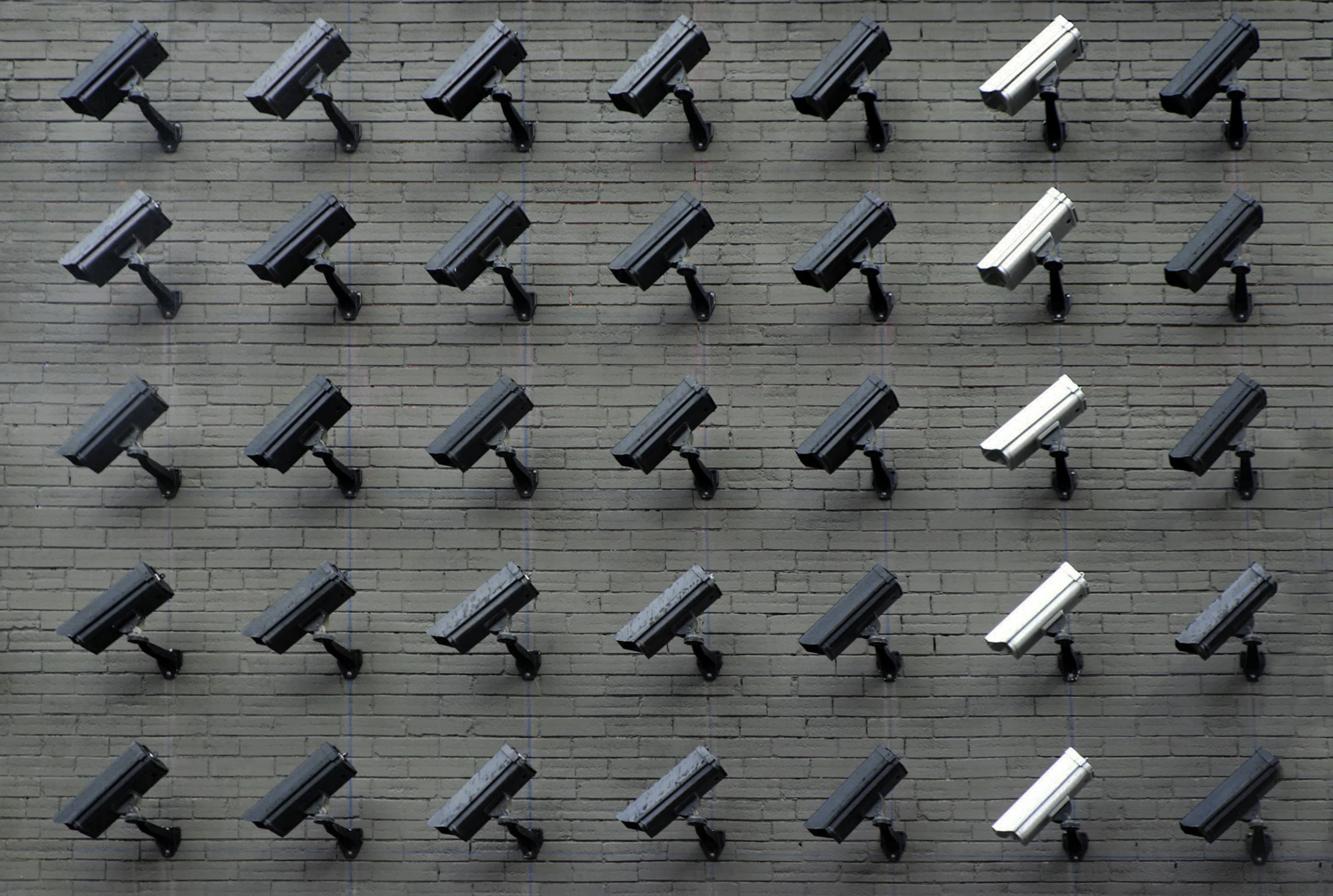 A wall of surveillance monitors displaying multiple video feeds